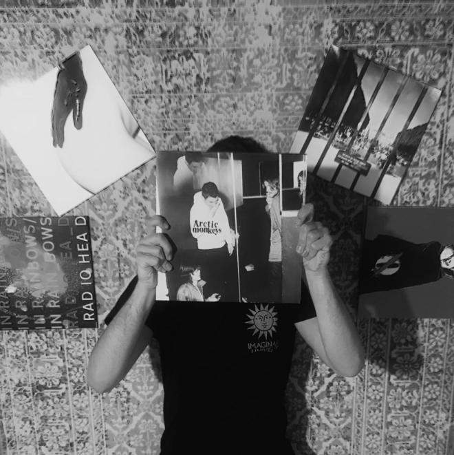 Mężczyzna trzyma płytę Arctic Monkeys - "Humbug".